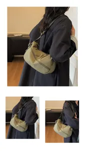 Detail of olive green nylon crescent crossbody bag with adjustable wide strap and zip closure