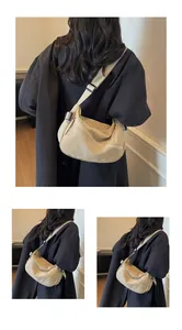 Macro detail of the durable nylon fabric texture and adjustable shoulder strap on beige bag
