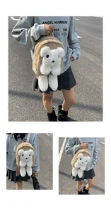 Detail of plush brown bear backpack with cute white stuffed doll and metal zipper