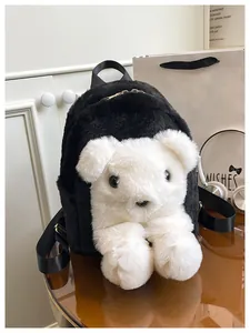 Detail of plush black and white bear backpack with fluffy texture and metal zipper closure