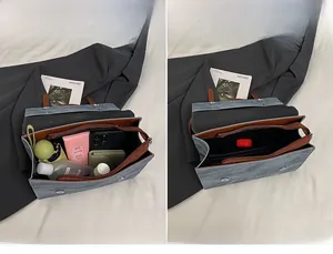 Détail intérieur d'un sac en denim bleu avec garniture en cuir montrant sa grande capacité