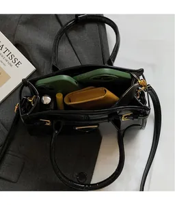 Top view of spacious black leather handbag interior showing organized everyday essentials