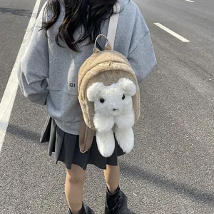 Cute khaki faux fur teddy bear shoulder bag with white plush pup on street style background