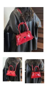 Detailed views of red patent faux leather handbag with triangle logo and gold hardware