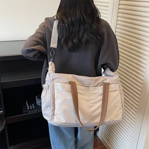 Large capacity travel duffel bag with front plaid pocket and adjustable strap