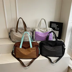 Large capacity travel duffel bags in multiple colors with reinforced handles and crossbody strap