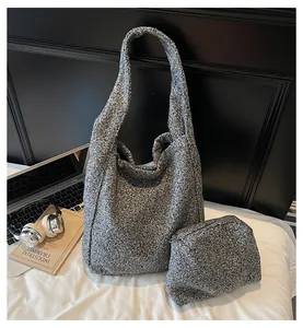 Macro detail of grey woolen tote bag set with matching pouch and soft fabric texture