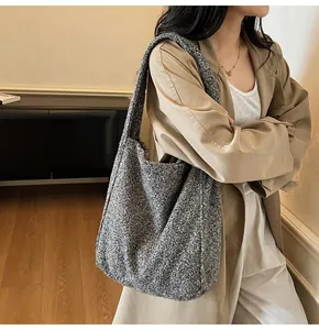 Detail of wool-textured tote bag showing gray boucle fabric and large capacity