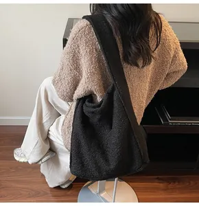 Detail shot of the fuzzy black faux shearling texture on a large hobo tote bag