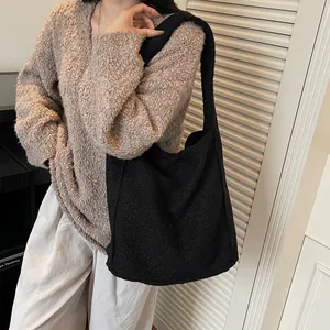 Fashionable black faux shearling tote bag for women featuring large capacity and soft texture