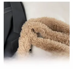 Detail of soft brown faux fur shoulder strap on a black blazer showing plush texture