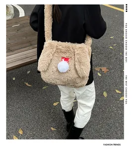 Detail of cute rabbit-themed khaki plush shoulder bag featuring long ears and white pompom