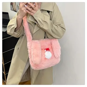 Close-up of a pink plush rabbit ear bag featuring soft faux fur and a fuzzy pom-pom