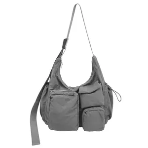 Minimalist grey nylon tote bag with multiple functional pockets and adjustable strap