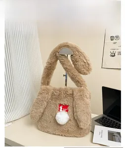 Detailed close-up of khaki plush shoulder bag featuring cute bunny ears and a soft pompom