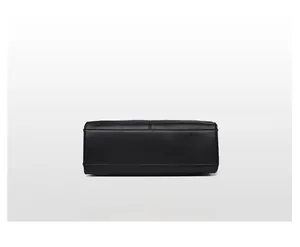 Detailed view of the reinforced bottom stitching and black lychee grain leather texture