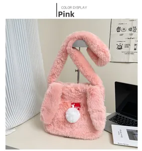 Detailed view of pink plush shoulder bag featuring cute long bunny ears and white pompom
