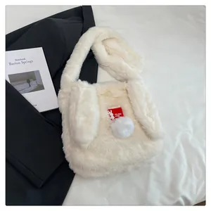 Detailed texture of white plush rabbit ear shoulder bag with soft faux fur and red tag