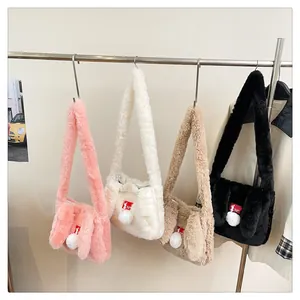 Detail view of plush rabbit ear shoulder bags in multiple colors with furry pom-pom