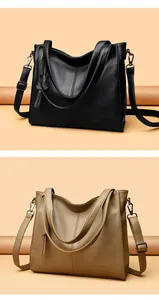 Detailed view of black and khaki pebbled leather tote bags with adjustable straps