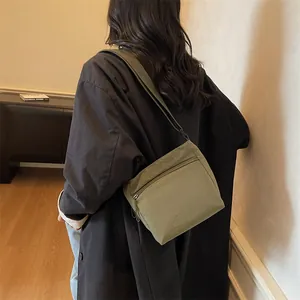 Minimalist olive green nylon crossbody bag with adjustable strap and large capacity