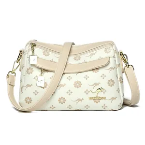Sac bandoulière beige avec imprimé floral kangourou et logo kangourou doré