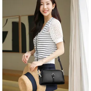 Sac à bandoulière minimaliste en cuir grainé noir avec ornement argenté élégant