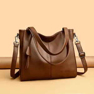 Detailed macro view of litchi grain texture and brand logo on brown tote bag