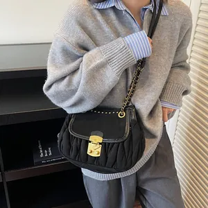 Chic black pleated shoulder bag with gold chain strap and metal lock clasp for women