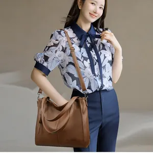 Brown leather large capacity tote bag with adjustable shoulder strap and minimalist design