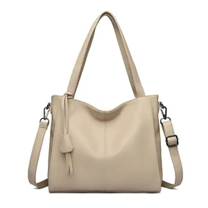 Beige litchi grain leather tote bag with top handles and adjustable shoulder strap