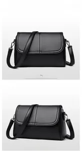 Dettaglio borsa nera in pelle testurizzata con ganci in metallo e cuciture decorative