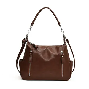 Fashionable dark brown leather tote bag with side pockets and adjustable shoulder strap