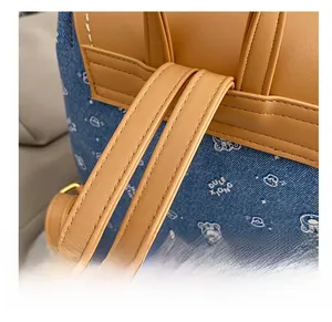Detail showing durable denim fabric with bear patterns and reinforced leather shoulder straps