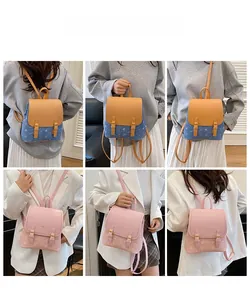 Mini denim and pink backpacks shown on model highlighting versatile carrying options