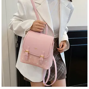 Pink mini bear backpack with adjustable metal straps shown on a model in casual style