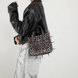 Leopard print tote bag with metal studs and gothic cross detail in a stylish punk design