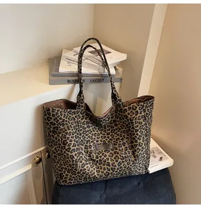 Close-up of leopard print canvas tote bag featuring a practical front pocket detail