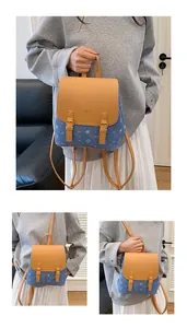 Detail view of mini denim and leather patchwork backpack with cute cartoon bear prints