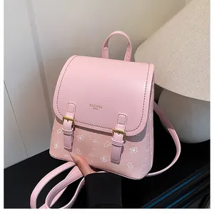 Detail of pink PU leather backpack with gold buckles and white cartoon bear patterns