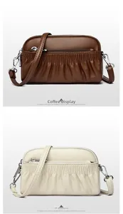 Detail of genuine leather crossbody bags in coffee and off-white with pleated textures