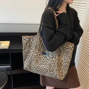 Large capacity leopard print canvas tote bag on female model in a minimalist setting