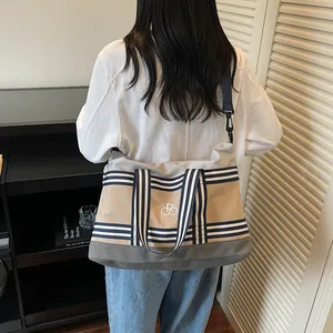 Large travel duffel bag with canvas patchwork, bicycle embroidery and shoulder strap