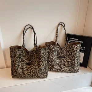 Large leopard print canvas tote bags in dark and light brown patterns with exterior pocket