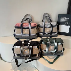 Lightweight minimalist travel duffel bags with contrast webbing and crossbody straps