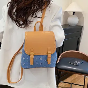 Blue denim mini backpack with cute bear prints and brown leather flap for casual travel