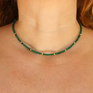 Minimalist beaded necklace with green faceted stones and 18k gold plated steel accents