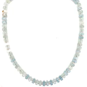 Close-up of light blue natural stone beads and silver spacers on bohemian necklace