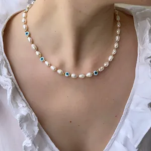 Vintage baroque pearl necklace with Turkish evil eye beads and gold accents worn by model
