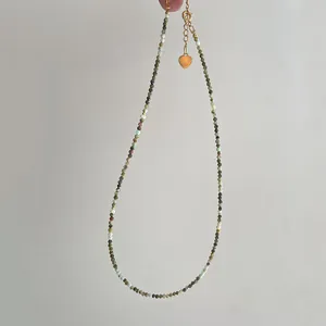 Minimalist pearl necklace with earth-tone natural stones and gold heart pendant charm